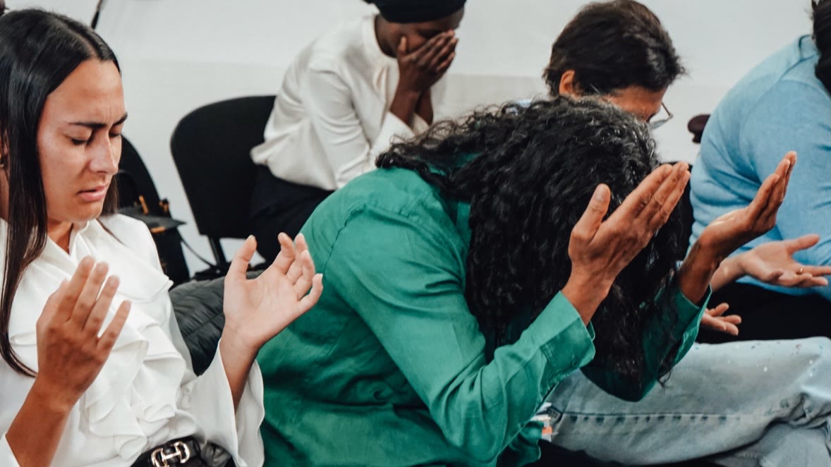 People praying during the September 27 service at River Church Frankfurt